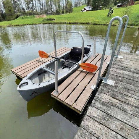 Mr Launcher Kayak Dock on a wooden dock with a calm lake and greenery in the background