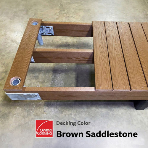 A section of brown composite deck boards installed on a wooden frame with metal brackets, suitable for floating dock applications. Labeled Decking Color: Brown Saddlestone by Owens Corning.