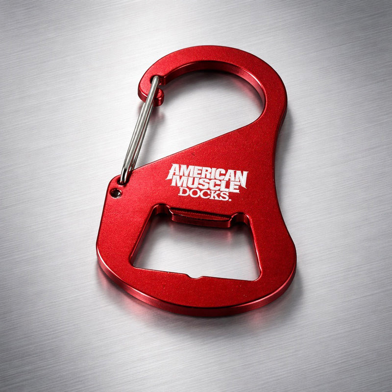The Carabiner Bottle Cap Opener by American Muscle Docks is a durable red metal tool with a built-in bottle opener, ideal for multi-use convenience.