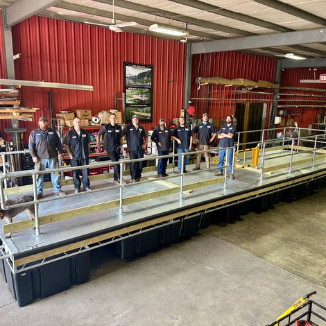 AMD Fabrication crew standing on a large dock build in a warehouse setting