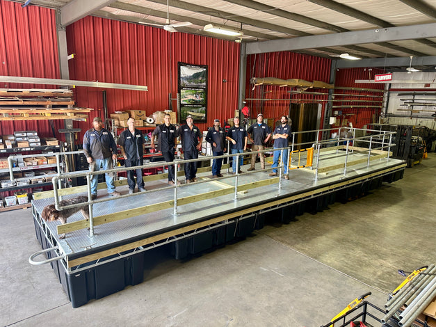 AMD Fabrication crew standing on a large dock build in a warehouse setting