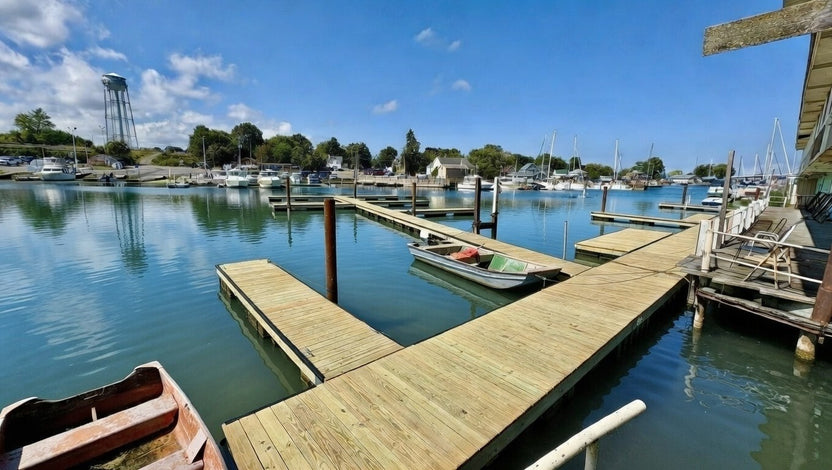 Marina with wooden docks and boats on a clear day