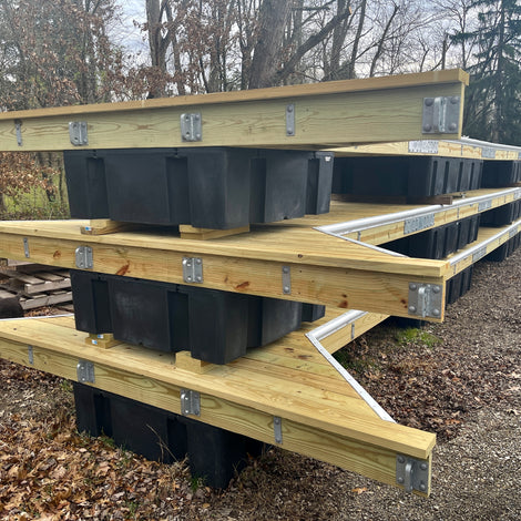 wooden floating docks stacked in yard built by American Muscle Docks