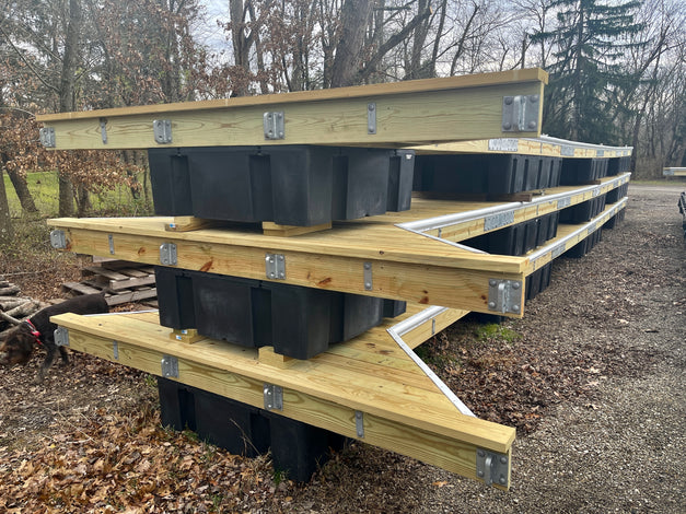 wooden floating docks stacked in yard built by American Muscle Docks