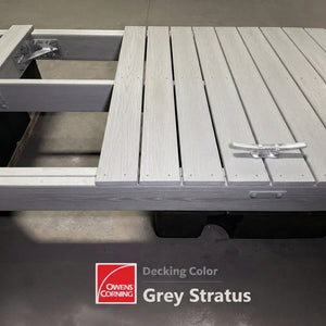 A floating dock made of grey composite decking with a cleat attached, labeled as Owens Corning Decking Color: Grey Stratus.