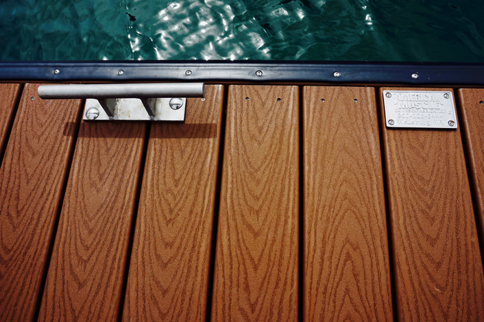 wood dock floating in the water with cleat and plaque built by American Muscle Docks