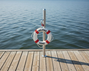 Life buoy with 'Helping Hand' text on a wooden dock by the water
