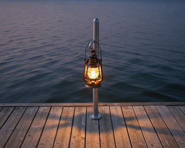 Helping Hand with a lantern on a dock by the water at night