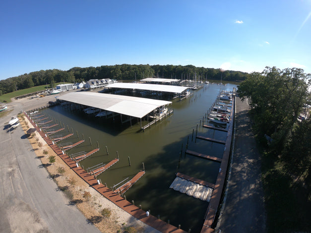 Marina with steel channel docks and boats on a clear day